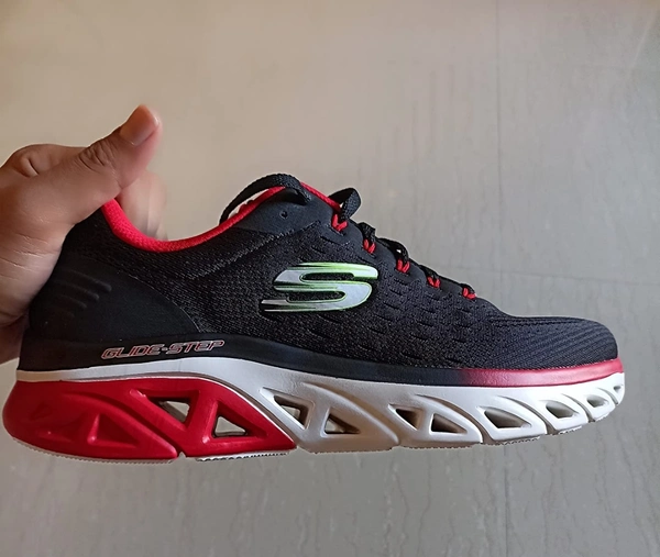 A-Man-Holding-Black-and-Red-Colour-Skechers-Shoes-And-Click-Picture